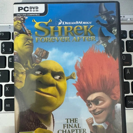 Shrek Forever After PC DVD ROM game case on a laptop keyboard background.
