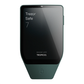 A dark green Trezor Safe 7 hardware wallet device with a black screen displaying 'Trezor Safe 7' and 'secured with TROPIC01'.