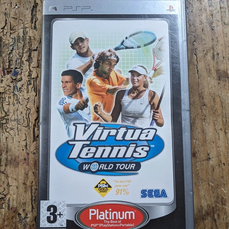 A PlayStation Portable game case for Virtua Tennis World Tour, featuring cover art of tennis players and logos for Platinum and SEGA, photographed on a textured wooden surface.
